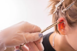 Professional ear piercing procedure during body piercing training in Utah